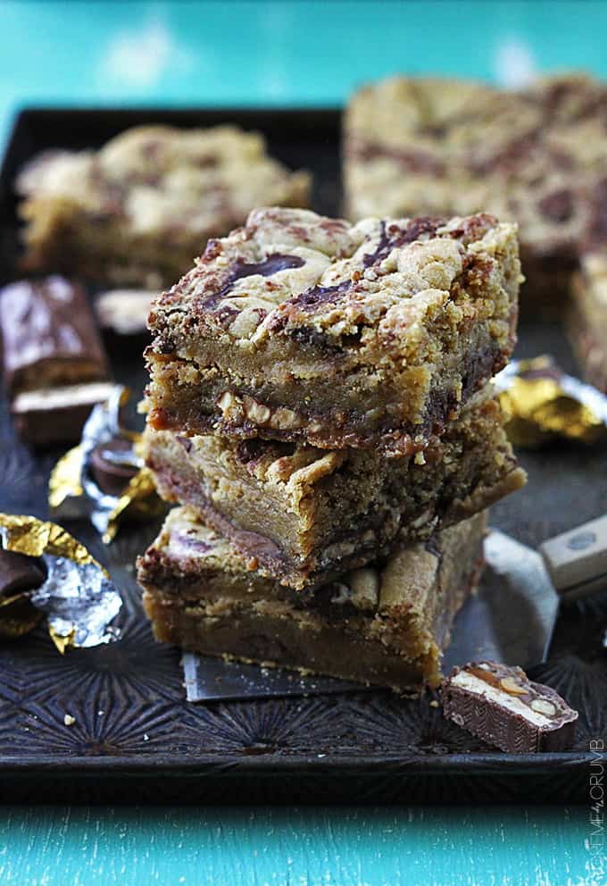 stacked kerplunky bars with snicker candy. pieces and more bars faded in the background