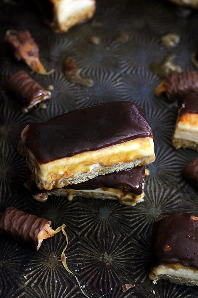 stacked Twix ice cream bars surrounded by more bars and Twix candy bars.