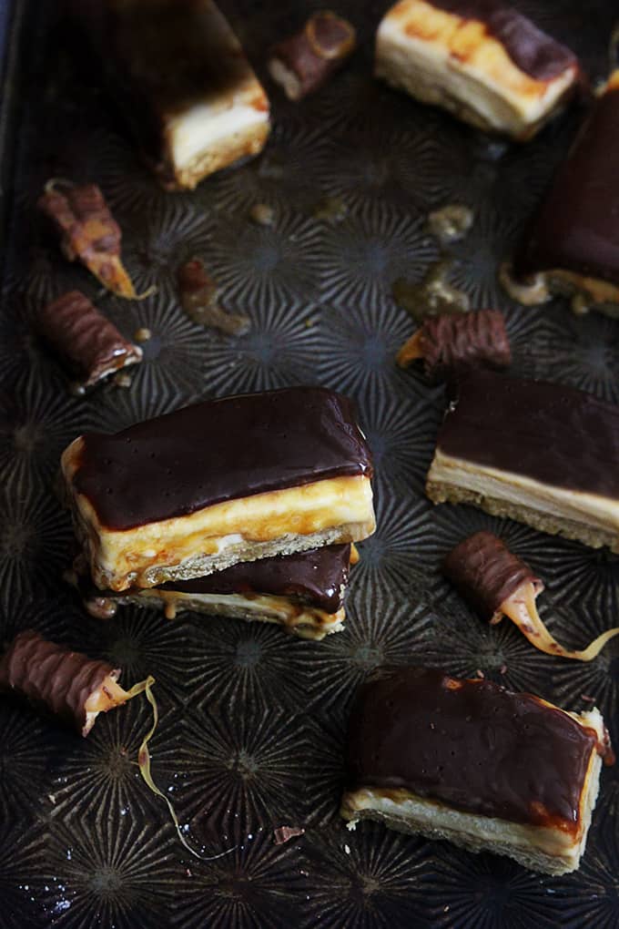 stacked Twix ice cream bars surrounded by more bars and Twix candy bars.