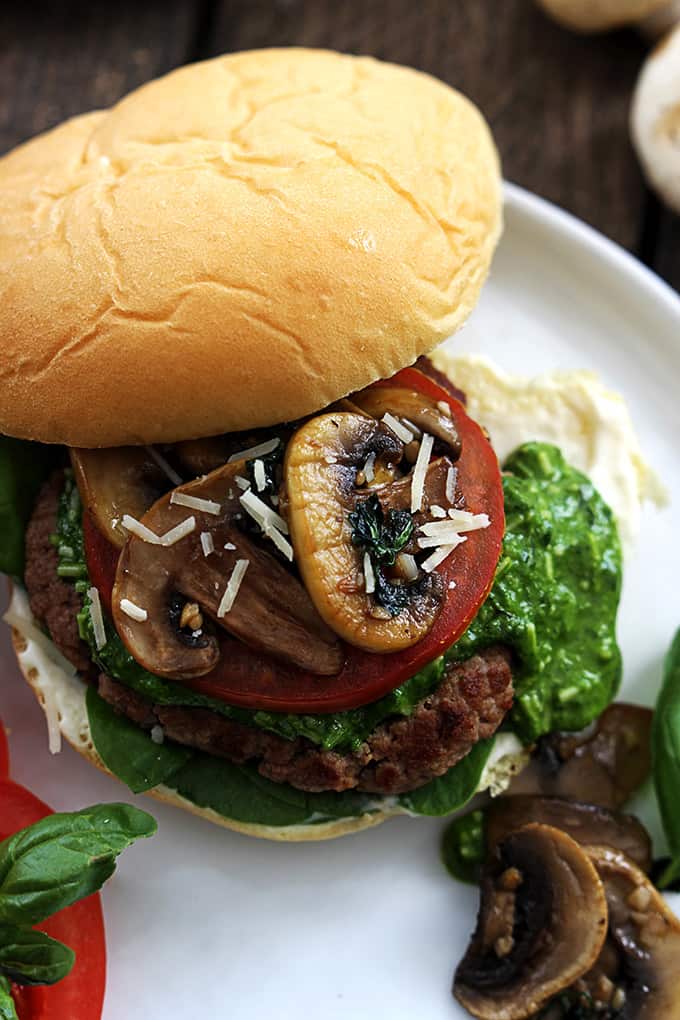 close up top view of a garlic pesto turkey burger on a plate.