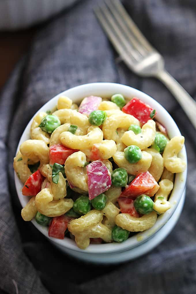 top view of honey dijon macaroni salad in a bowl with a fork on the side.