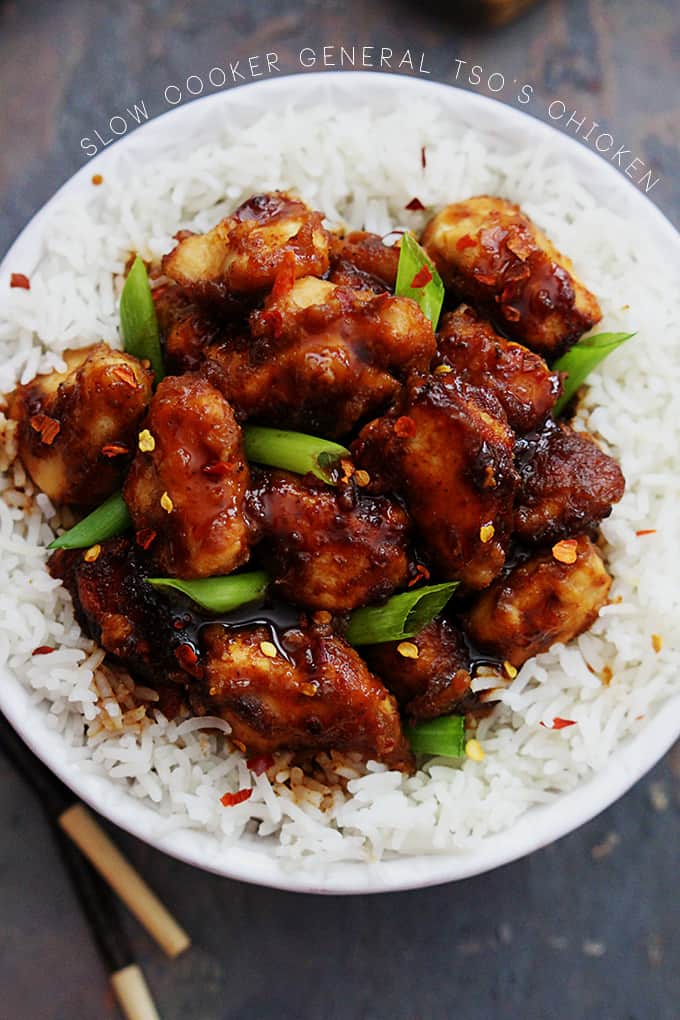 top view of general tso's chicken on rice in a bowl with the title of the recipe going around the top middle of the bowl.