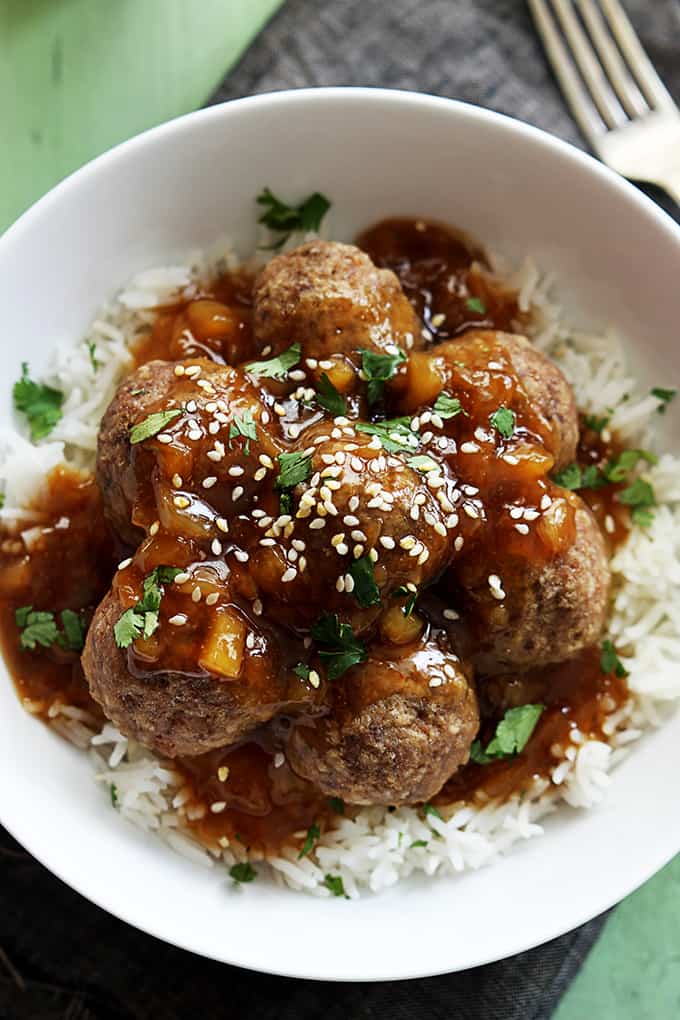 top view of Hawaiian meatballs on rice in a bowl with a fork on the side.