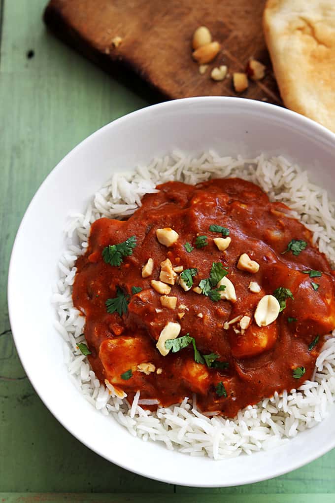 top view of Indian butter chicken on rice in a bowl.