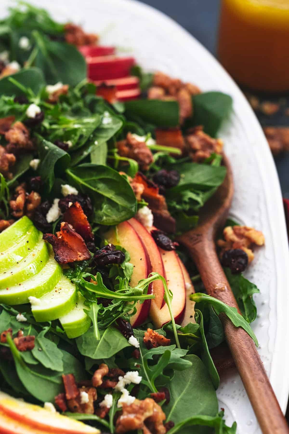 apple cranberry walnut salad with serving spoon