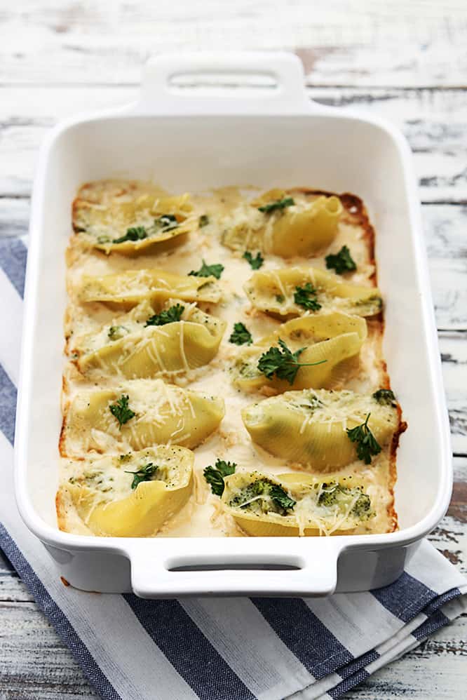 broccoli alfredo stuffed shells in a serving tray.