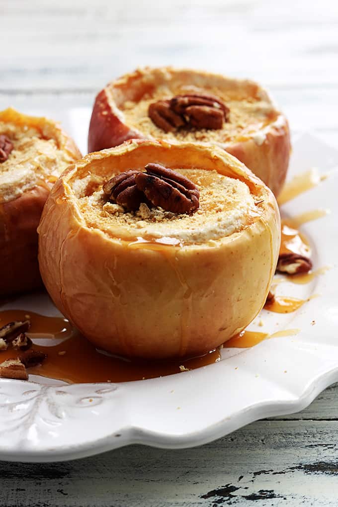 cheesecake stuffed baked apples on a plate.