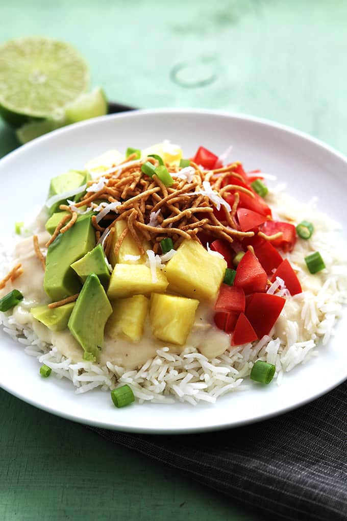 slow cooker Hawaiian haystacks on a plate with a sliced and half of a lime on the side.