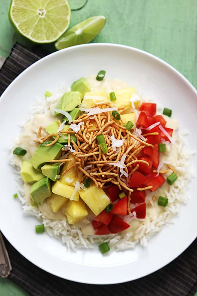 top view of slow cooker Hawaiian haystacks on a plate with a slice and a half of a lime on the side.