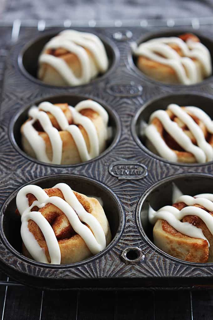 close up of a muffin tin with mini cinnamon rolls.