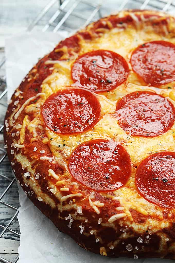 close up of pretzel crust pizza on a cooling rack.