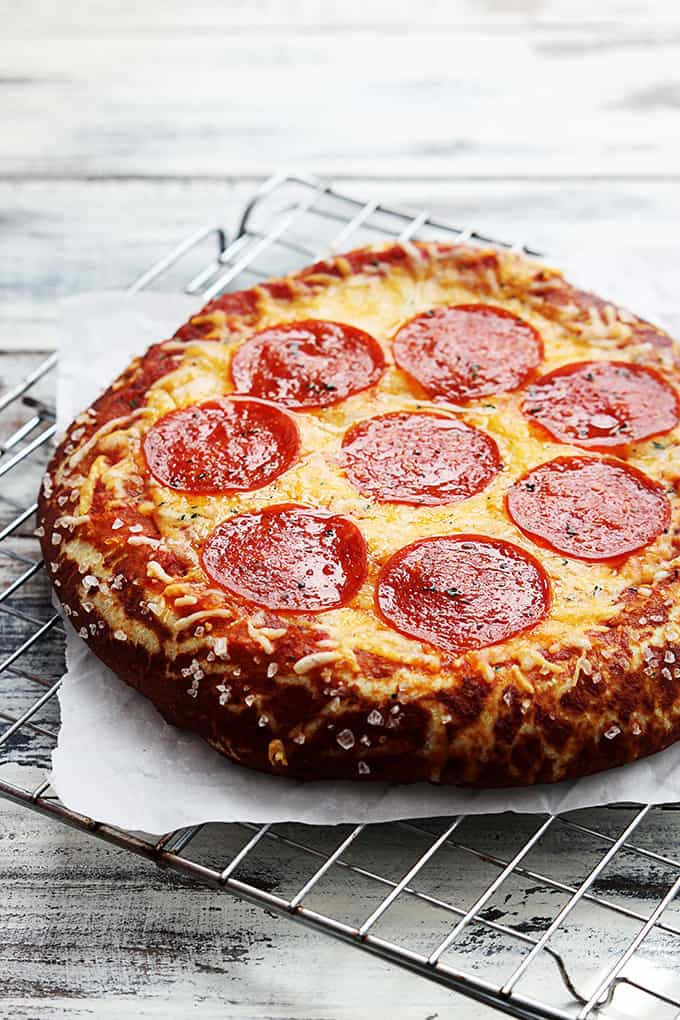 pretzel crust pizza on a cooling rack.