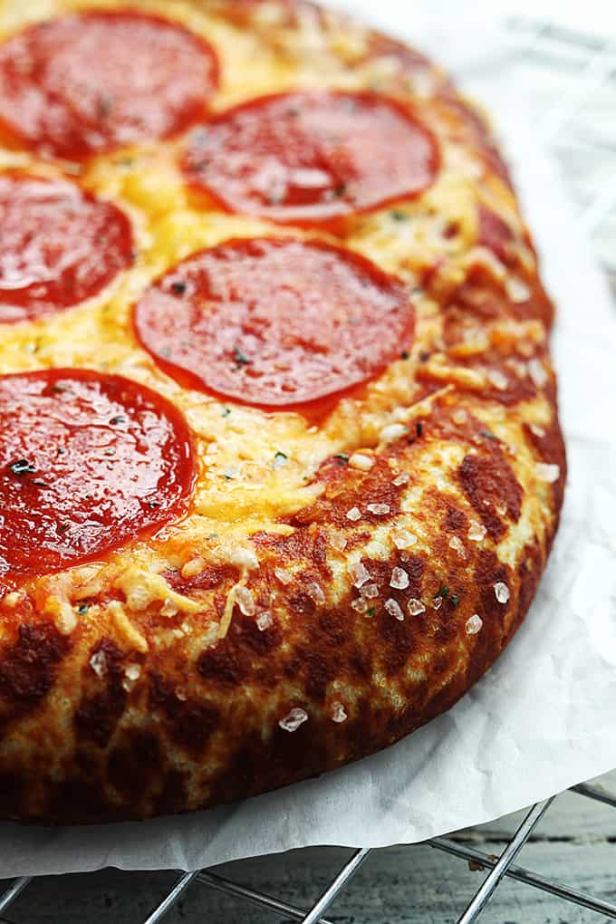 close up of pretzel crust pizza on a cooling rack.