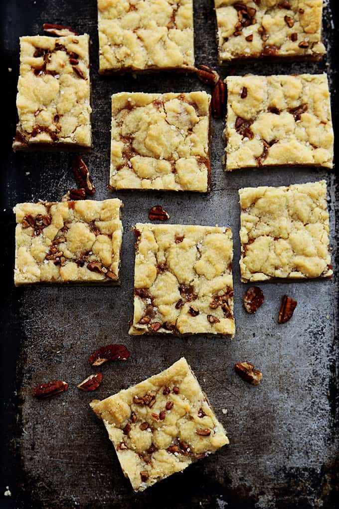 top view of salted caramel pecan butter bars on a baking sheet.