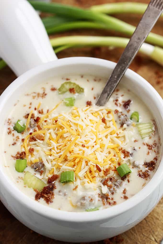 top view of slow cooker cheeseburger soup with a spoon in a bowl.