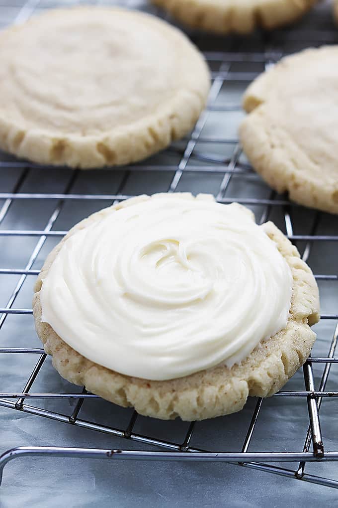 eggnog sugar cookies on a baking sheet with the front one frosted.