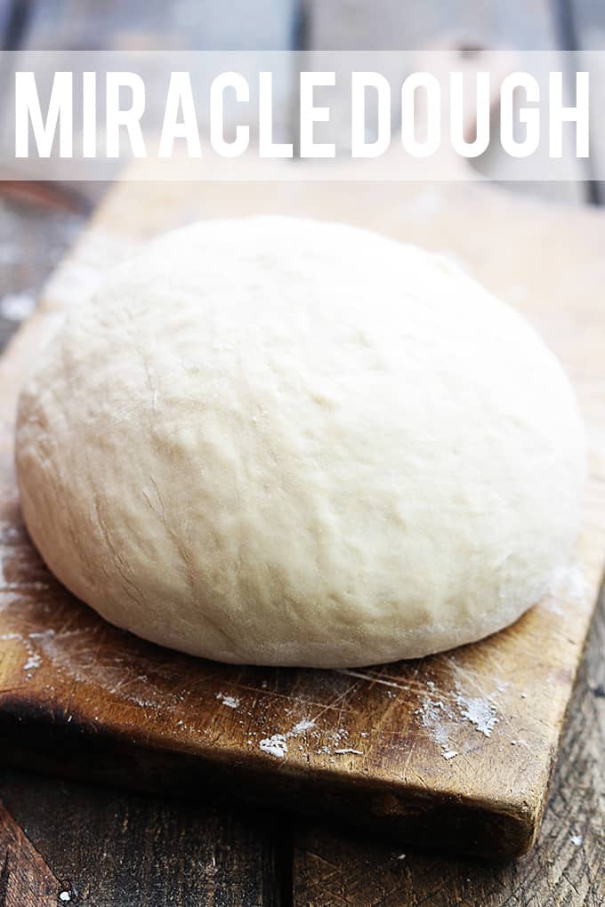 a ball of dough on a cutting board with the "miracle dough" written on the top of the image.