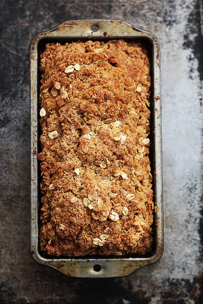 top view of a loaf of cinnamon streusel pumpkin bread in a bread pan.