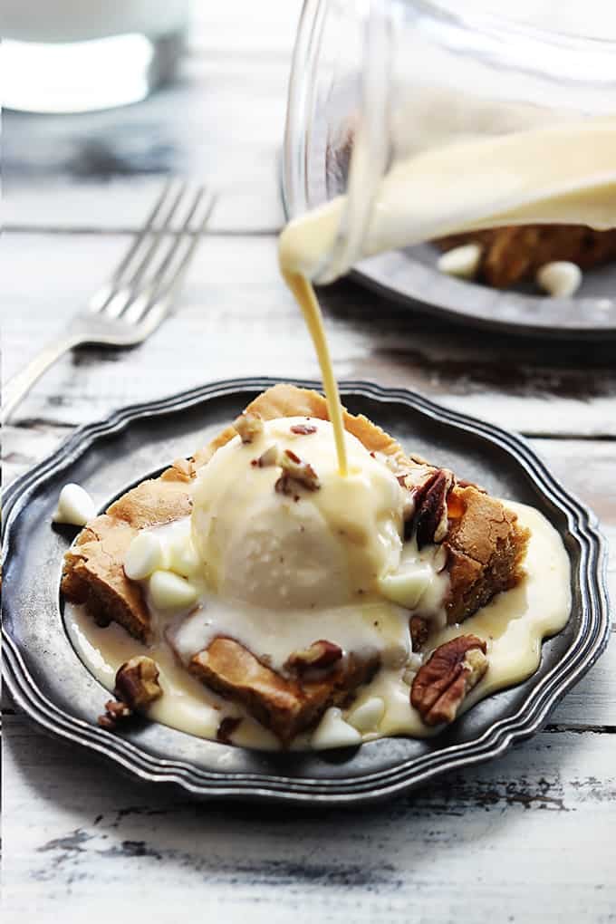 Applebee's maple nut blondie with cream sauce being poured on top.