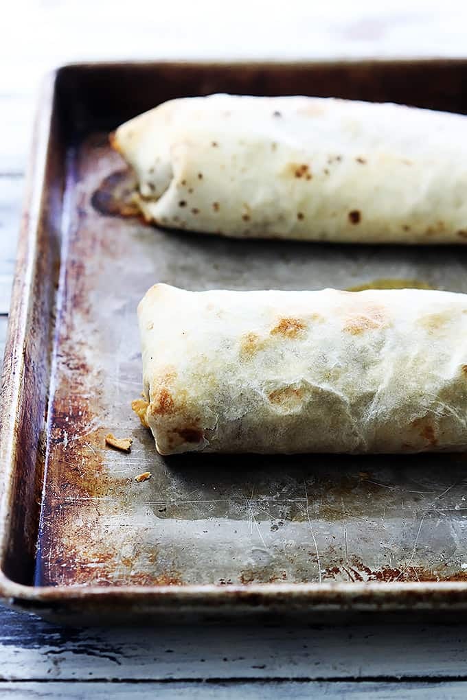 baked chicken chimichangas on a baking sheet.