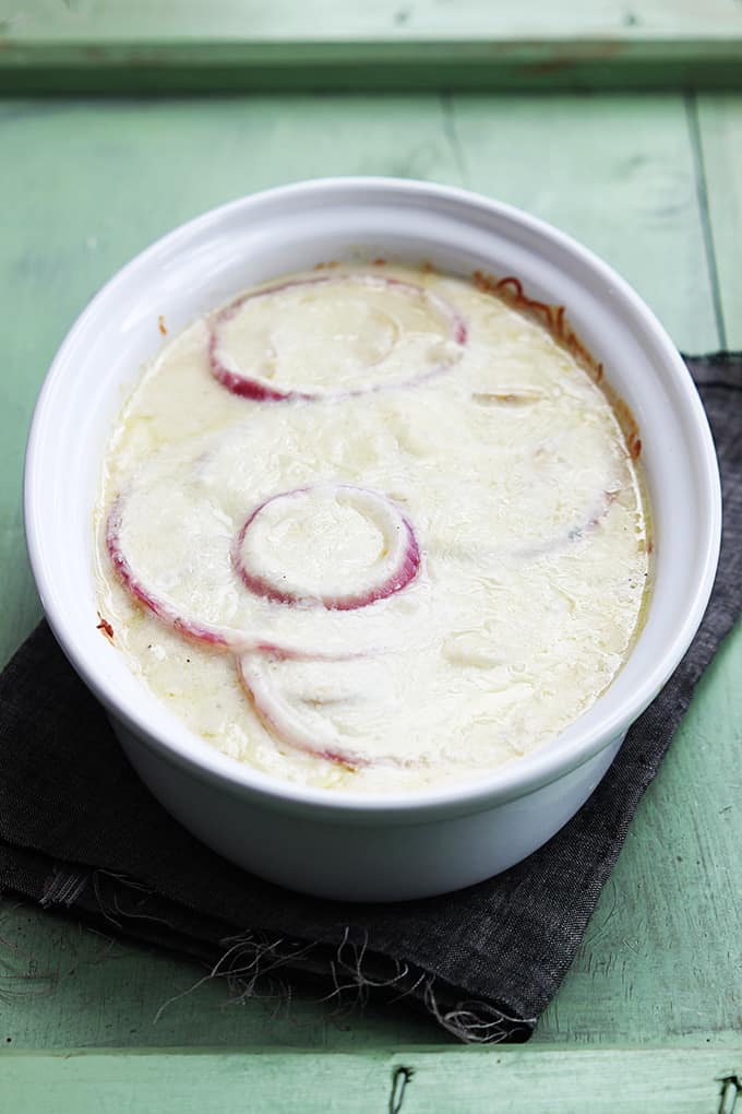 French onion scalloped potatoes without the crunchy onion topping in a serving dish.