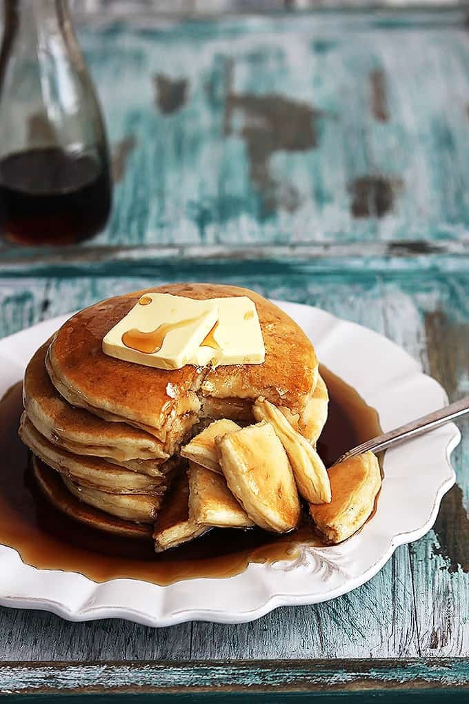 a stack of greek yogurt pancakes on a plate topped with butter and syrup on top.