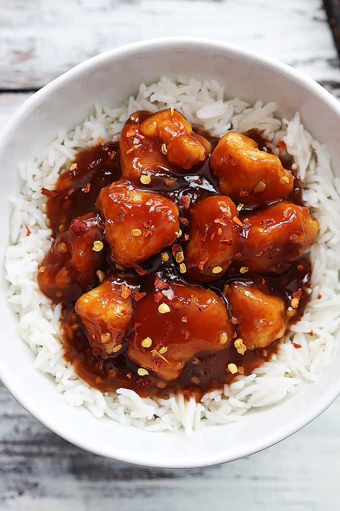 top view of honey sriracha chicken on rice in a bowl.