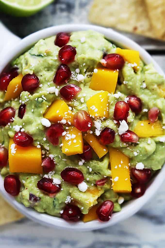 close up top view of mango pomegranate guacamole in a bowl.