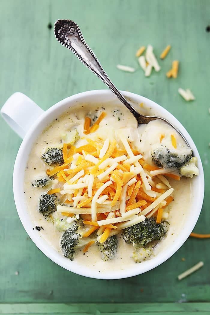 top view of slow cooker broccoli cheese soup in a bowl with a spoon on top.