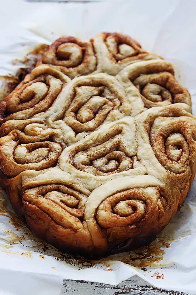 slow cooker cinnamon rolls on parchment paper.