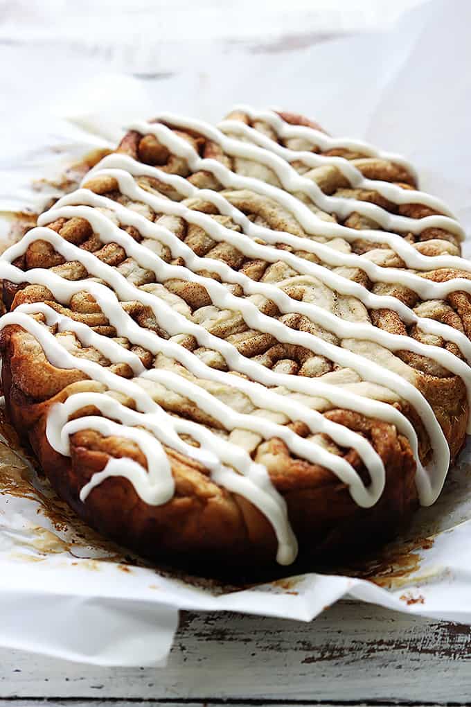 slow cooker cinnamon rolls with icing on top.