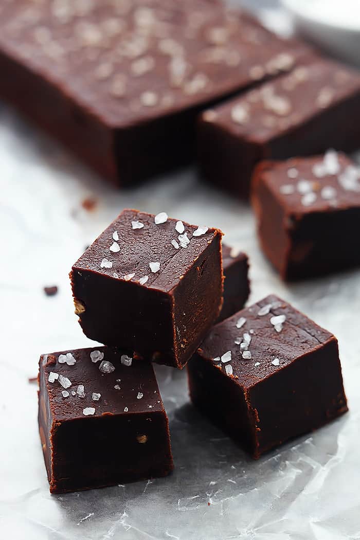 stacked slow cooker fudge cubes with more fudge faded in the background.