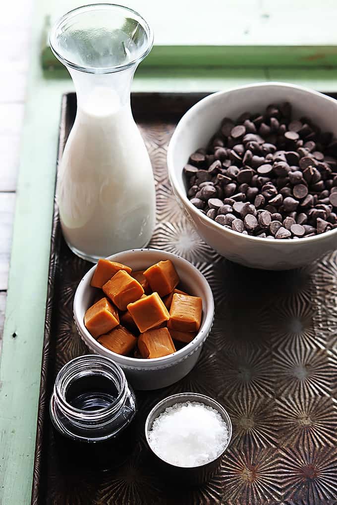 slow cooker salted caramel hot chocolate ingredients on a baking sheet.