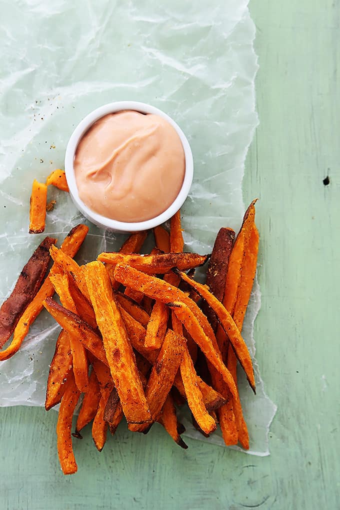 top view of sweet potato fries and a bowl of fry sauce.