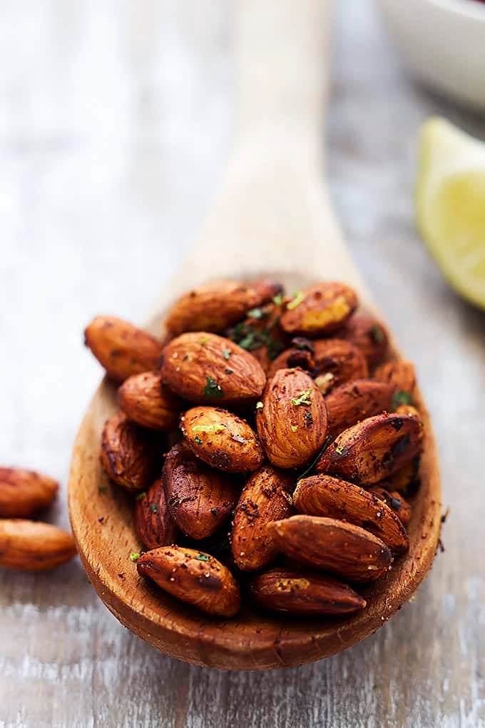 chili lime almonds on a wooden serving spoon.