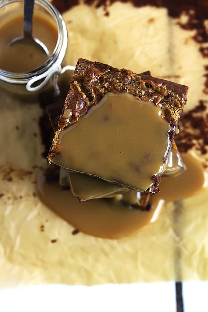 top view of stacked Dulce de Leche brownies with Dulce de Leche sauce on top with more sauce in a jar on the side.
