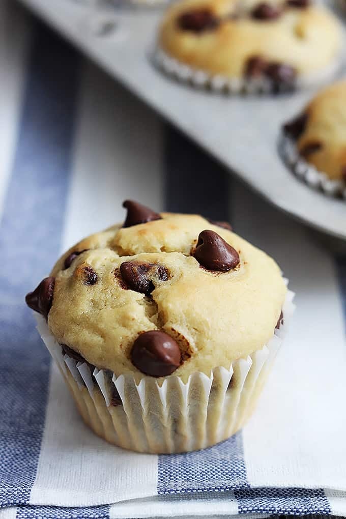 close up of a greek yogurt muffin with a muffin tin in the background.