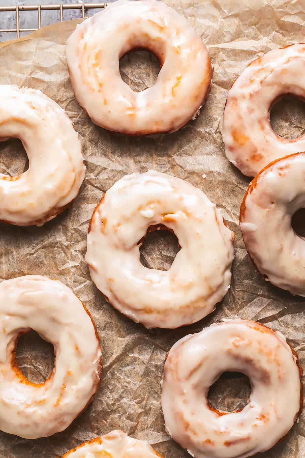 Overhead of old fashioned sour cream donuts on parchment paper.