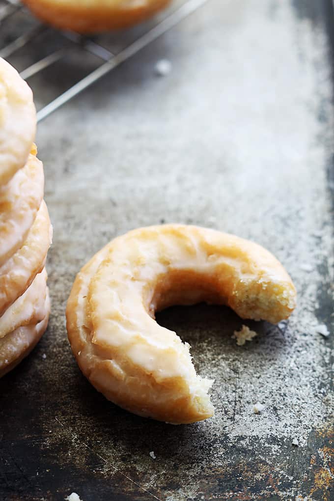 an old fashioned sour cream donut with a bite missing.