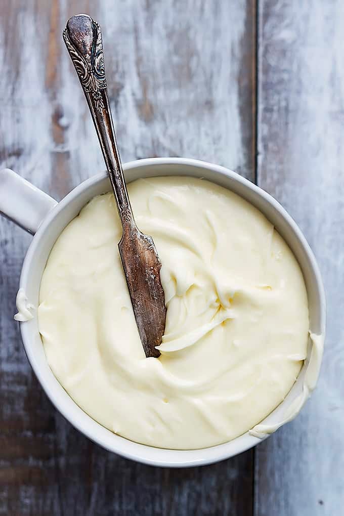 top view of a bowl of frosting with a frosting knife.