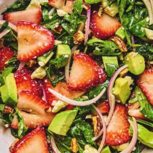 Close up of strawberry avocado salad in a serving dish.