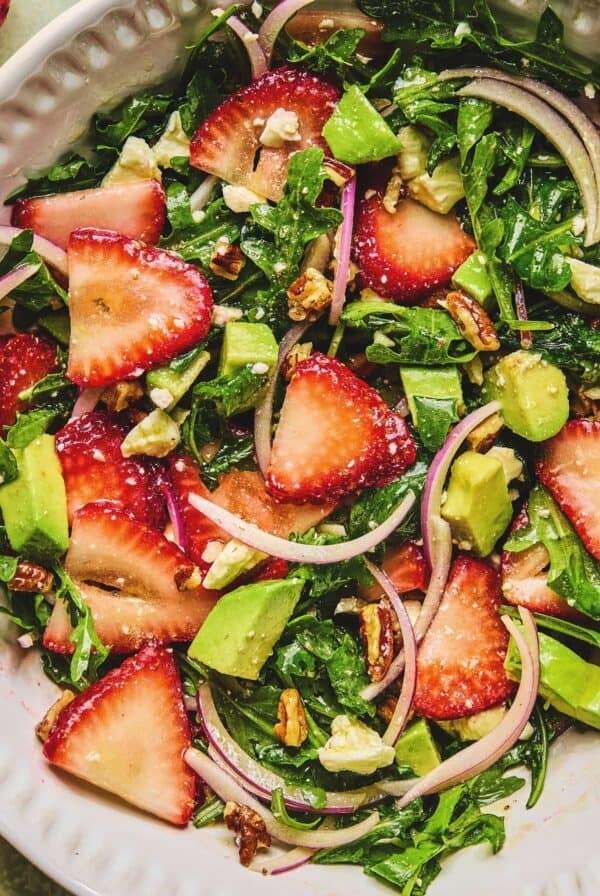 Close up of strawberry avocado salad in a serving dish.