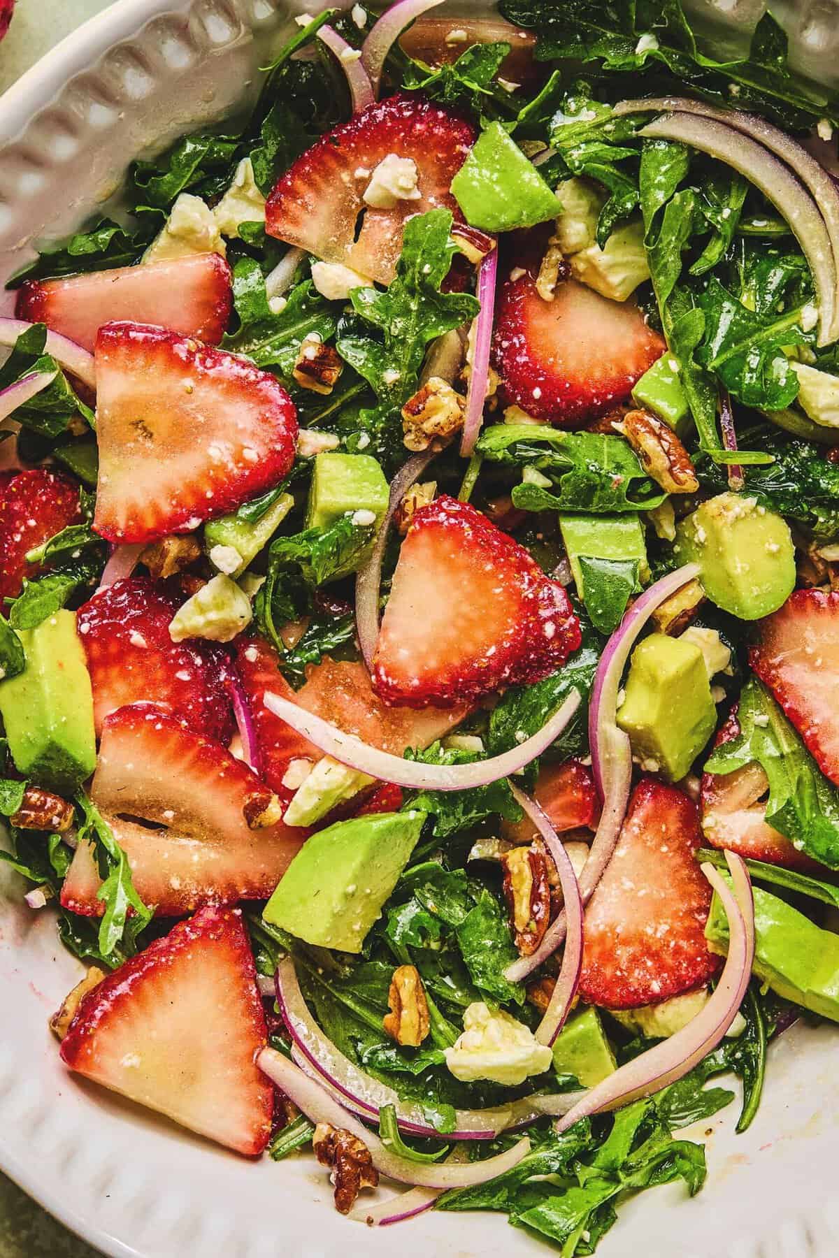Close up of strawberry avocado salad in a serving dish.