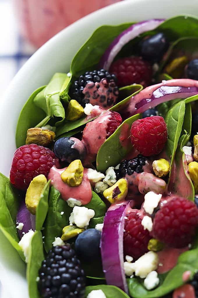 close up of berry lover's spinach salad with berry vinaigrette in a bowl.
