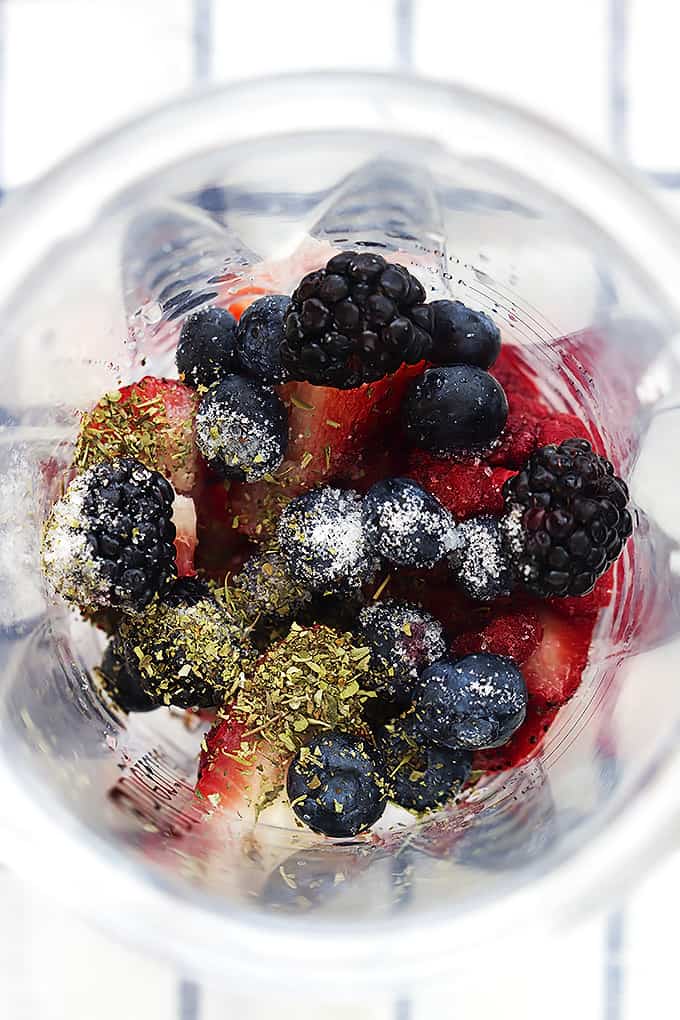 top view of berry vinaigrette ingredients unmixed in a blender.