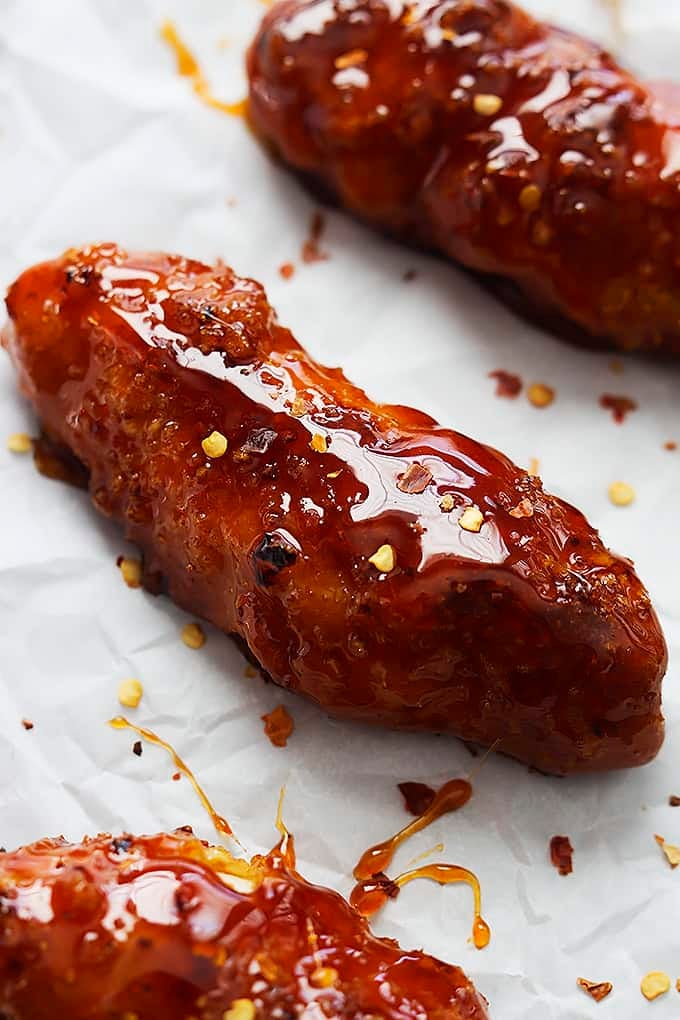 close up of baked firecracker chicken tenders on parchment paper.