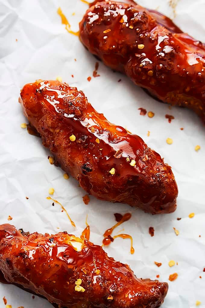 baked firecracker chicken tenders on parchment paper.