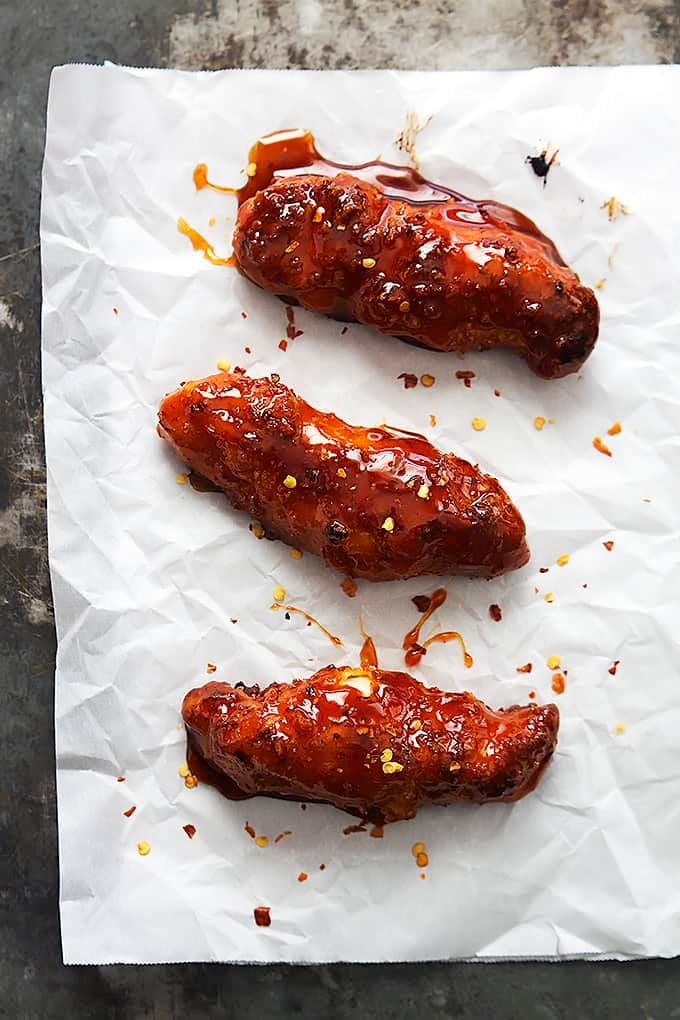 top view of baked firecracker chicken tenders on parchment paper.