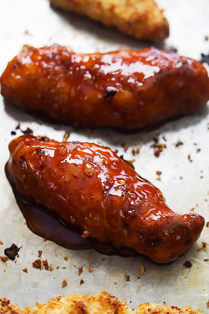 baked firecracker chicken tenders on parchment paper.