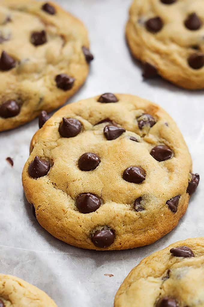 close up of hot fudge stuffed chocolate chip cookies on a baking sheet.